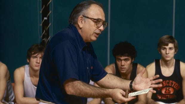 Pete Carril directs Princeton players through a play scheme.